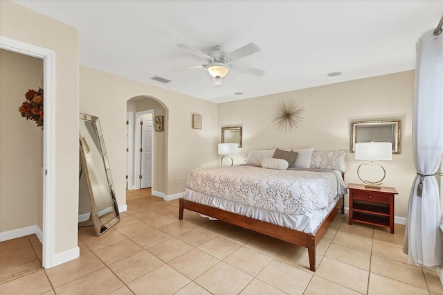 7280 Muncey Rd, North Port, FL 34291 - bedroom with arched walkways, light tile patterned floors, and ceiling fan