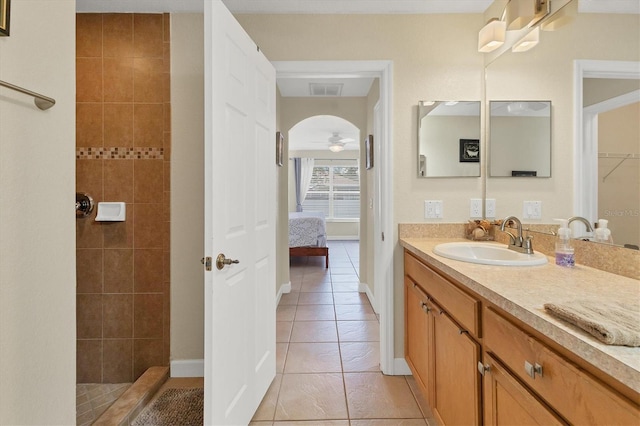 7280 Muncey Rd, North Port, FL 34291 - ensuite bathroom featuring vanity, tile patterned floors, tiled shower, ceiling fan, and a closet