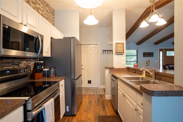 21220 Pemberton Ave, Port Charlotte, FL 33952 - kitchen with appliances with stainless steel finishes, a sink, white cabinets, dark countertops, and beamed ceiling