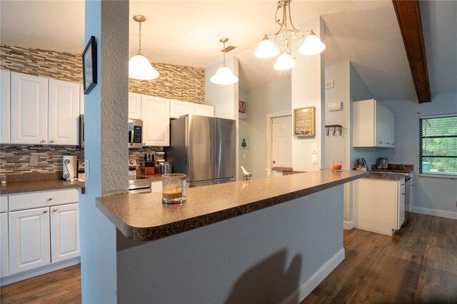 21220 Pemberton Ave, Port Charlotte, FL 33952 - kitchen with stainless steel appliances, white cabinets, tasteful backsplash, dark countertops, and high vaulted ceiling