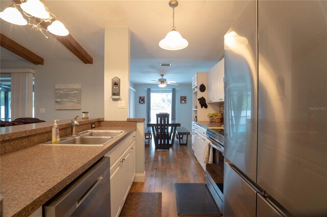 21220 Pemberton Ave, Port Charlotte, FL 33952 - kitchen with stainless steel appliances, a sink, white cabinetry, wood finished floors, and ceiling fan
