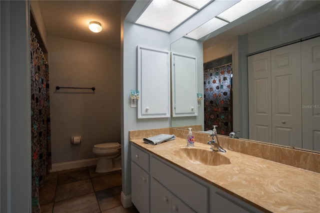21220 Pemberton Ave, Port Charlotte, FL 33952 - bathroom with vanity, baseboards, toilet, and tile patterned floors