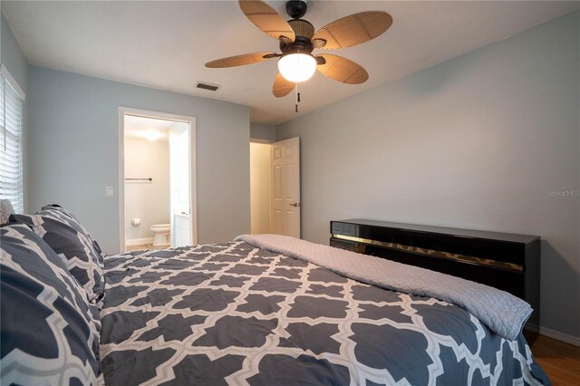 21220 Pemberton Ave, Port Charlotte, FL 33952 - bedroom with ensuite bath, baseboards, wood finished floors, and ceiling fan