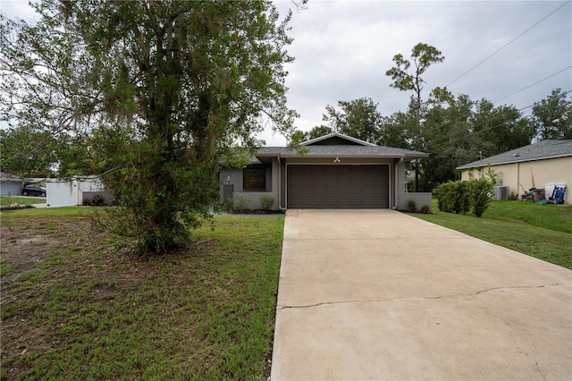 21220 Pemberton Ave, Port Charlotte, FL 33952 - ranch-style house with a garage, driveway, a front yard, and central AC