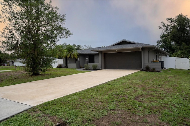 21220 Pemberton Ave, Port Charlotte, FL 33952 - ranch-style home with a garage, driveway, a gate, and stucco siding