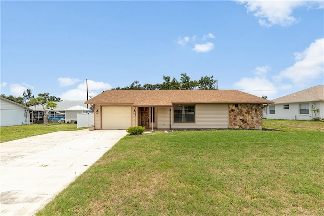 3242 Nocturne Rd, Venice, FL 34293 - ranch-style house with concrete driveway, an attached garage, a front lawn, and stone siding