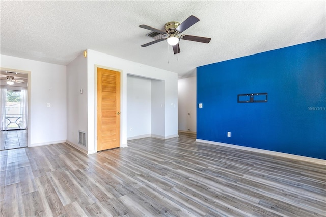 3242 Nocturne Rd, Venice, FL 34293 - unfurnished room with a ceiling fan, wood finished floors, and a textured ceiling