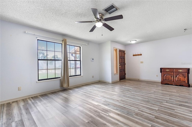 3242 Nocturne Rd, Venice, FL 34293 - empty room featuring light wood-type flooring, a textured ceiling, and ceiling fan