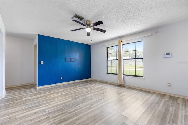3242 Nocturne Rd, Venice, FL 34293 - unfurnished room featuring wood finished floors, a textured ceiling, and ceiling fan