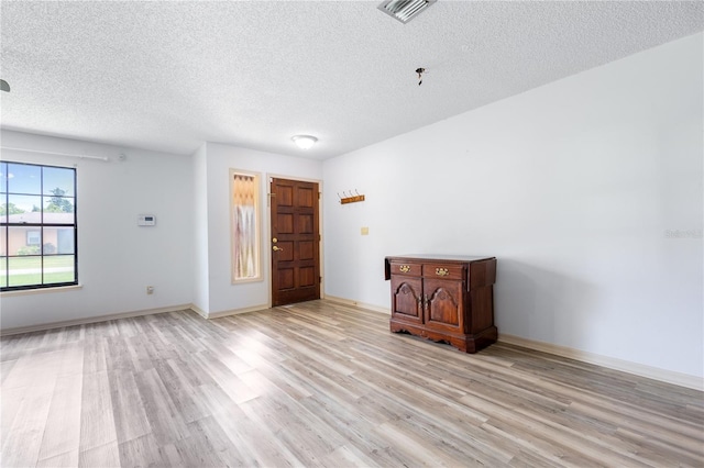 3242 Nocturne Rd, Venice, FL 34293 - foyer featuring light wood finished floors and a textured ceiling