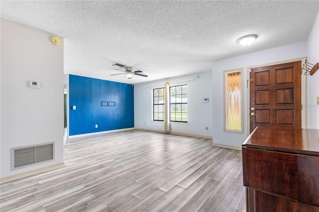 3242 Nocturne Rd, Venice, FL 34293 - foyer featuring a textured ceiling, a ceiling fan, and light wood finished floors