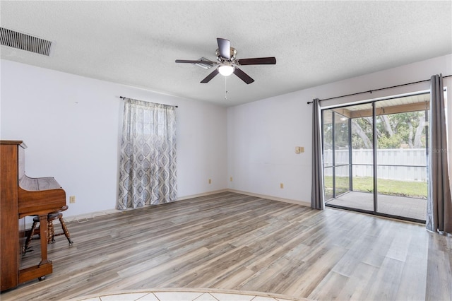 3242 Nocturne Rd, Venice, FL 34293 - spare room with light wood-type flooring, a ceiling fan, plenty of natural light, and a textured ceiling