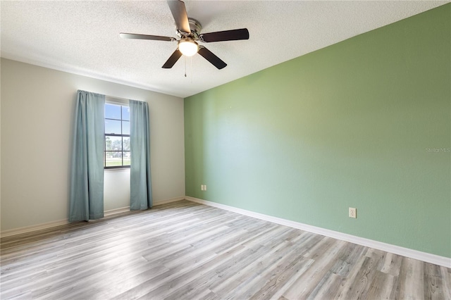 3242 Nocturne Rd, Venice, FL 34293 - empty room featuring wood finished floors, a ceiling fan, and a textured ceiling