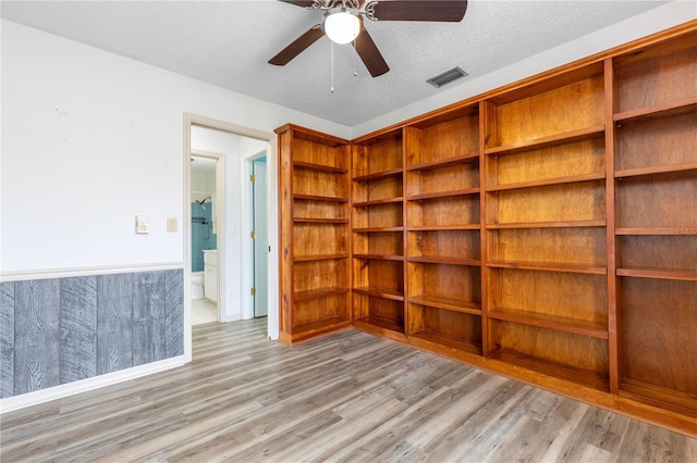 3242 Nocturne Rd, Venice, FL 34293 - empty room with light wood-style flooring, a ceiling fan, and a textured ceiling