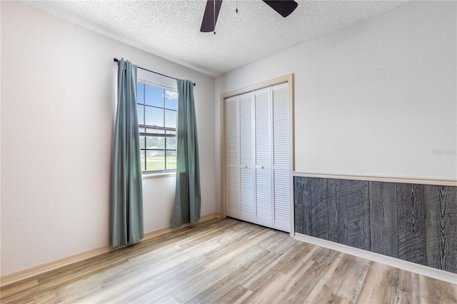 3242 Nocturne Rd, Venice, FL 34293 - unfurnished bedroom featuring wood finished floors, a closet, a textured ceiling, and a ceiling fan