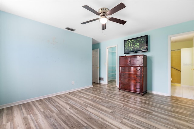 3242 Nocturne Rd, Venice, FL 34293 - unfurnished bedroom with wood finished floors, connected bathroom, and ceiling fan