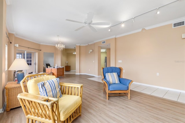 3730 Cadbury Cir Unit 616, Venice, FL 34293 - living area featuring crown molding, a ceiling fan, rail lighting, light wood finished floors, and a chandelier