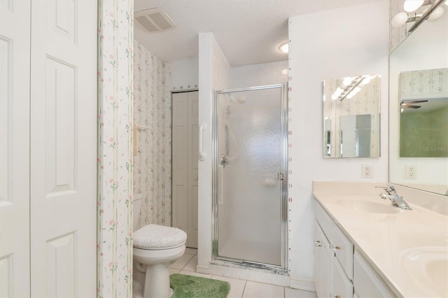 3730 Cadbury Cir Unit 616, Venice, FL 34293 - bathroom featuring tile patterned floors, a stall shower, double vanity, toilet, and wallpapered walls