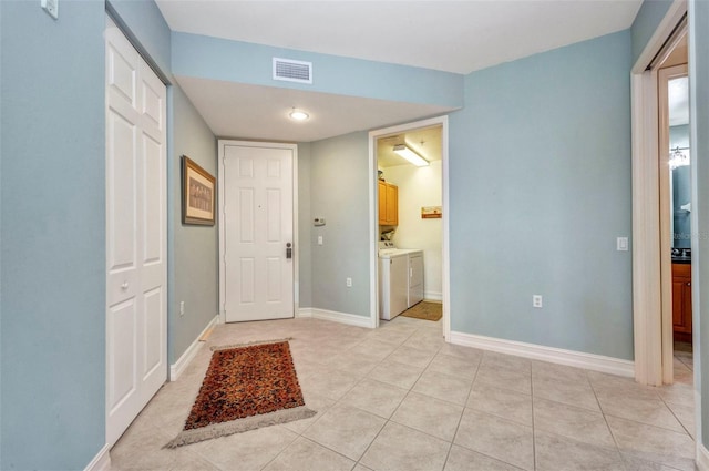 90 Vivante Blvd Unit 202, Punta Gorda, FL 33950 - entrance foyer featuring separate washer and dryer and light tile patterned floors