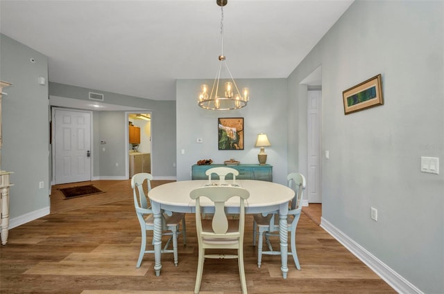 90 Vivante Blvd Unit 202, Punta Gorda, FL 33950 - dining area with a chandelier and wood finished floors