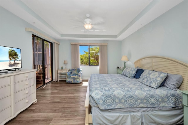 90 Vivante Blvd Unit 202, Punta Gorda, FL 33950 - bedroom with a raised ceiling, wood finished floors, access to outside, and ceiling fan