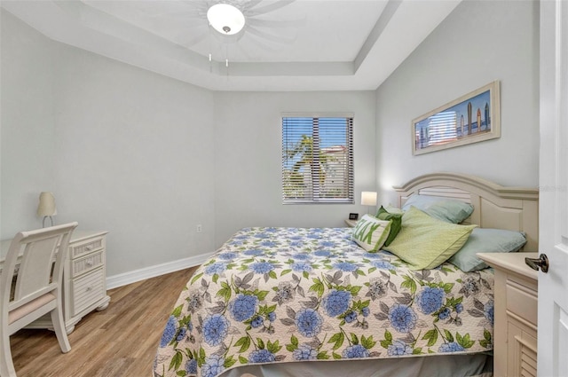 90 Vivante Blvd Unit 202, Punta Gorda, FL 33950 - bedroom featuring a raised ceiling, wood finished floors, and a ceiling fan