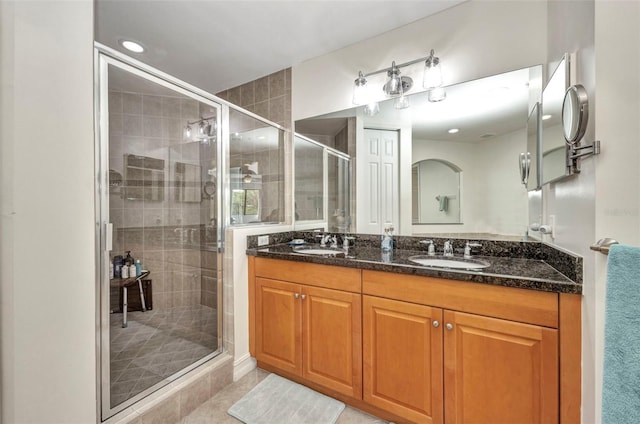 90 Vivante Blvd Unit 202, Punta Gorda, FL 33950 - bathroom with a shower stall, double vanity, tile patterned flooring, and recessed lighting