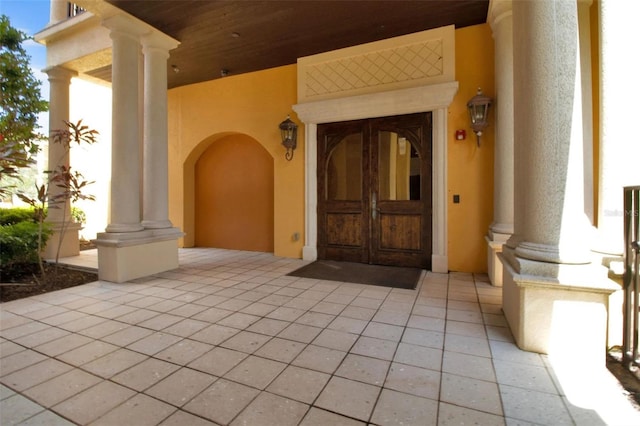 90 Vivante Blvd Unit 202, Punta Gorda, FL 33950 - view of exterior entry with stucco siding, french doors, and a porch