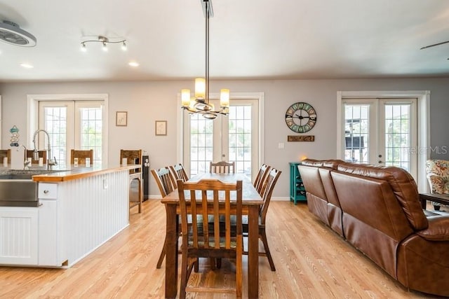 7424 Acorn Blvd, Punta Gorda, FL 33982 - dining area with french doors, light wood finished floors, plenty of natural light, and recessed lighting