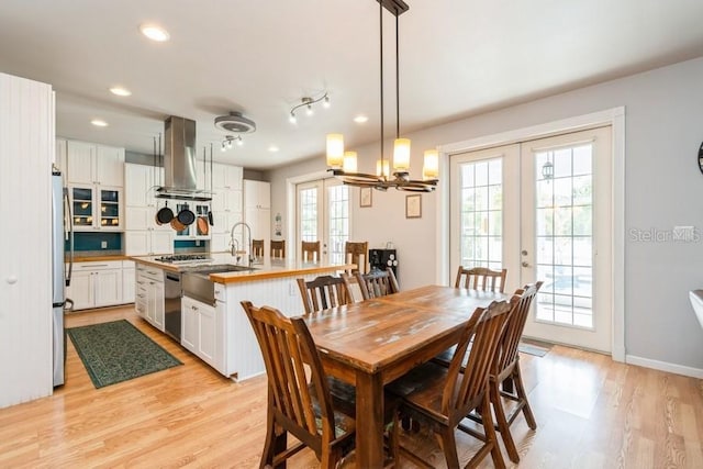 7424 Acorn Blvd, Punta Gorda, FL 33982 - dining area with french doors, light wood-style floors, recessed lighting, a chandelier, and baseboards