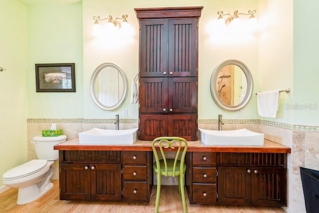 7424 Acorn Blvd, Punta Gorda, FL 33982 - full bathroom featuring tile walls, vanity, a wainscoted wall, toilet, and wood finished floors