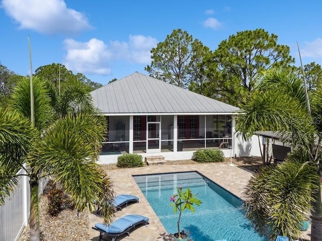 7424 Acorn Blvd, Punta Gorda, FL 33982 - rear view of property featuring a sunroom, a patio area, and an outdoor pool