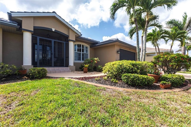 17150 Sarong Ln, Punta Gorda, FL 33955 - view of front of house featuring a garage, stucco siding, and a front yard