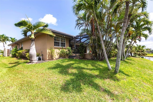 17150 Sarong Ln, Punta Gorda, FL 33955 - view of home's exterior with stucco siding, a yard, and a lanai