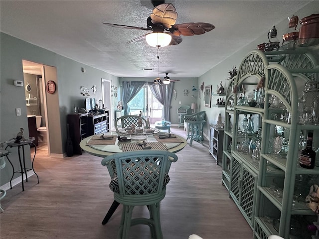 93 Boundary Blvd Unit 303, Rotonda West, FL 33947 - dining space featuring ceiling fan, wood finished floors, a textured ceiling, and baseboards