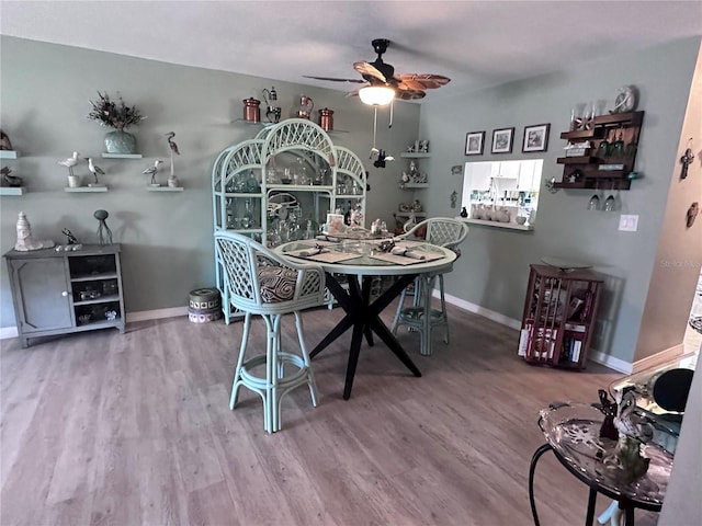 93 Boundary Blvd Unit 303, Rotonda West, FL 33947 - dining room featuring a ceiling fan, wood finished floors, and baseboards