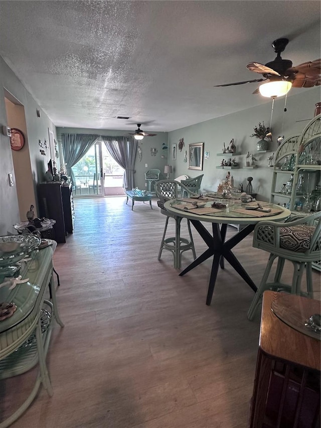 93 Boundary Blvd Unit 303, Rotonda West, FL 33947 - dining area featuring a ceiling fan, wood finished floors, and a textured ceiling