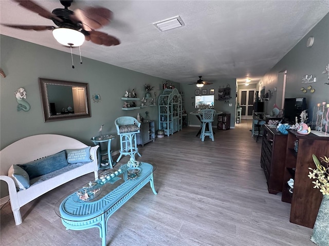 93 Boundary Blvd Unit 303, Rotonda West, FL 33947 - living room featuring a ceiling fan, wood finished floors, and a textured ceiling