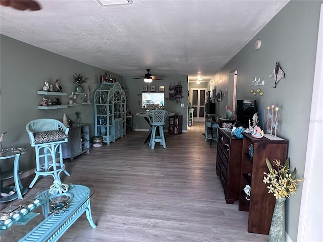 93 Boundary Blvd Unit 303, Rotonda West, FL 33947 - living area featuring ceiling fan, wood finished floors, and a textured ceiling