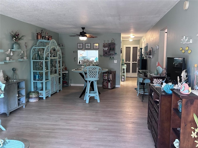 93 Boundary Blvd Unit 303, Rotonda West, FL 33947 - dining area with a ceiling fan, light wood finished floors, and a textured ceiling