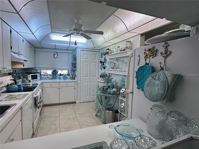 93 Boundary Blvd Unit 303, Rotonda West, FL 33947 - kitchen with white appliances, under cabinet range hood, a ceiling fan, light countertops, and light tile patterned floors
