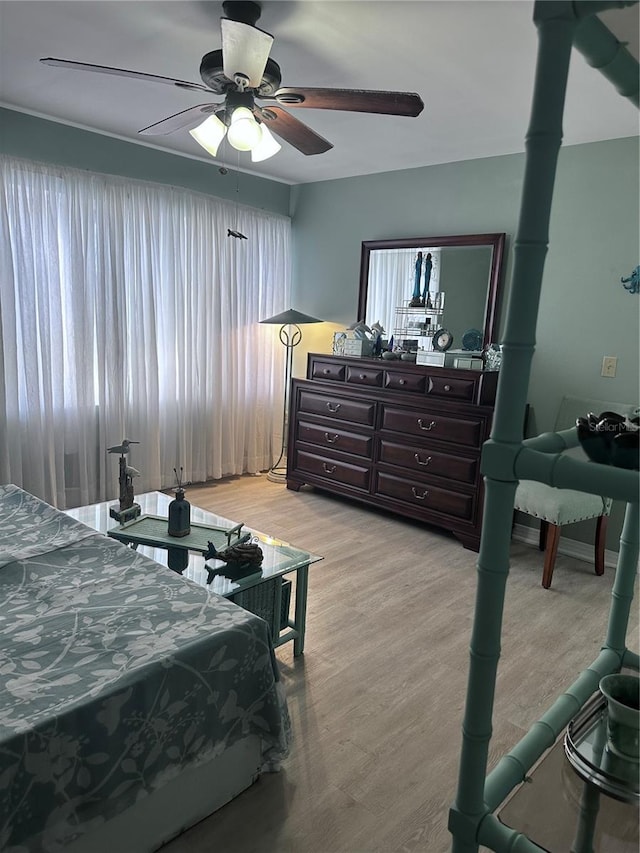 93 Boundary Blvd Unit 303, Rotonda West, FL 33947 - bedroom with light wood-type flooring and ceiling fan