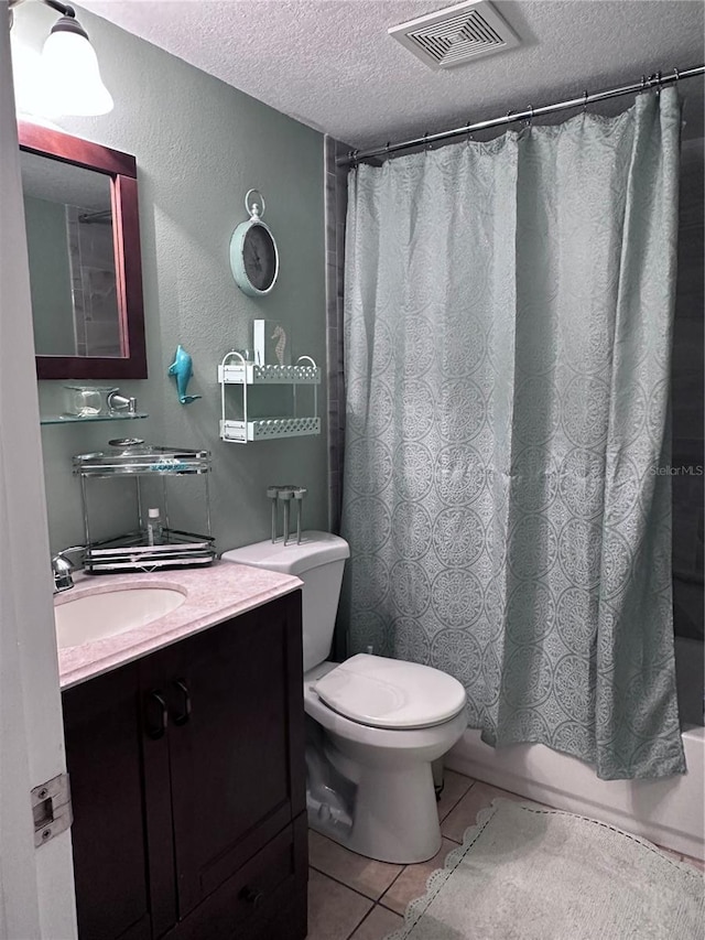 93 Boundary Blvd Unit 303, Rotonda West, FL 33947 - full bath with a textured ceiling, toilet, shower / tub combo with curtain, tile patterned floors, and vanity