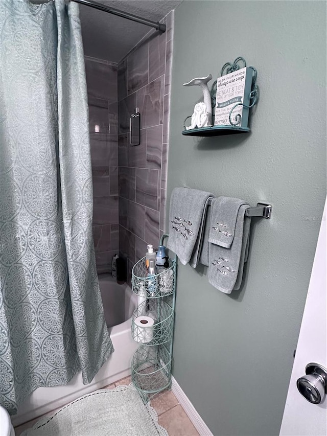 93 Boundary Blvd Unit 303, Rotonda West, FL 33947 - bathroom with shower / tub combo, tile patterned floors, and baseboards
