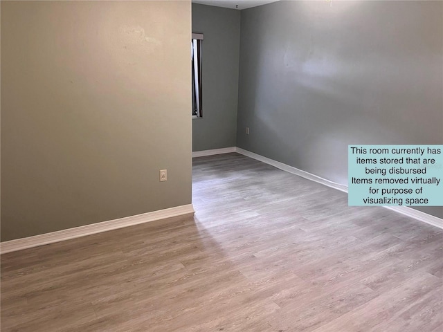 93 Boundary Blvd Unit 303, Rotonda West, FL 33947 - empty room with baseboards and wood finished floors