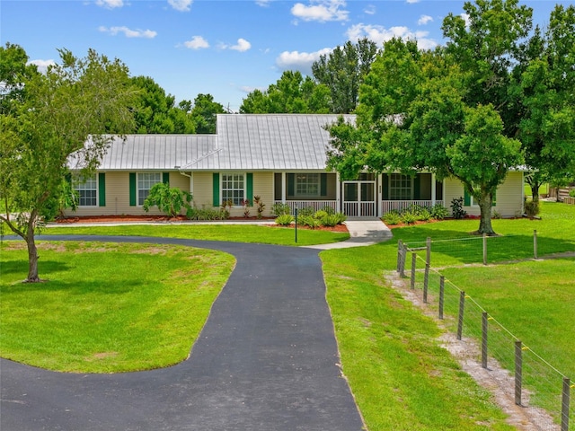 5221 Blackjack Cir, Punta Gorda, FL 33982 - ranch-style house with a porch, a metal roof, and asphalt driveway