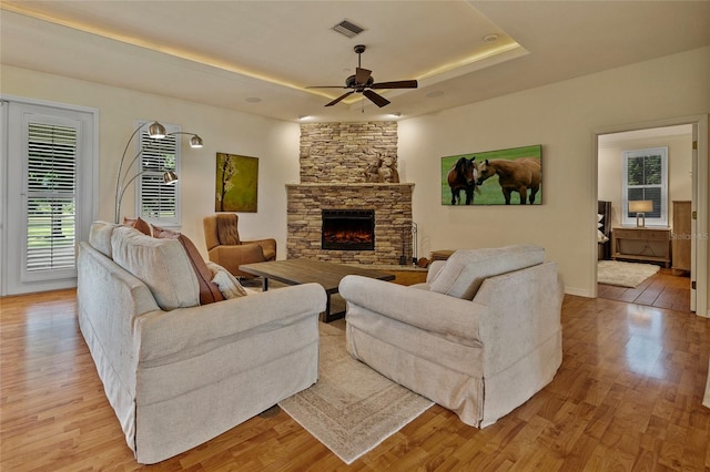 5221 Blackjack Cir, Punta Gorda, FL 33982 - living room featuring ceiling fan, light wood-type flooring, and a raised ceiling