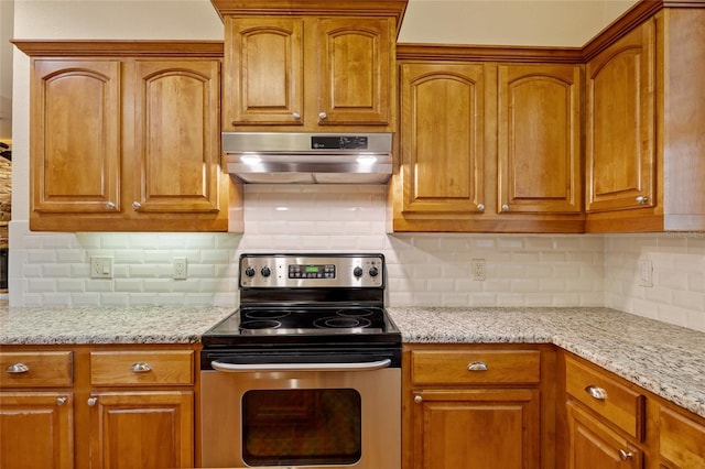5221 Blackjack Cir, Punta Gorda, FL 33982 - kitchen with stainless steel electric range, exhaust hood, tasteful backsplash, and light stone counters