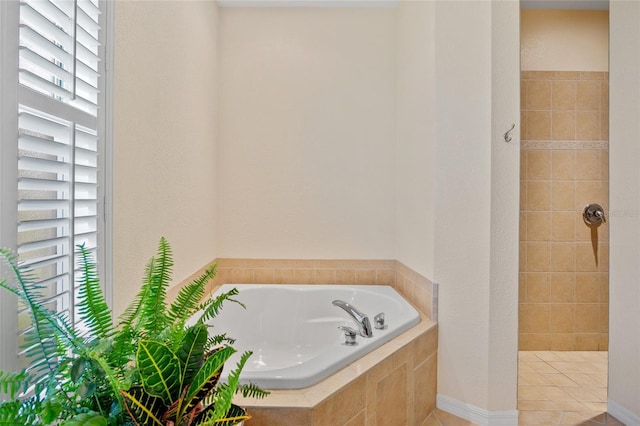 5221 Blackjack Cir, Punta Gorda, FL 33982 - bathroom featuring a garden tub, healthy amount of natural light, tiled shower, and tile patterned flooring