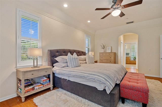 5221 Blackjack Cir, Punta Gorda, FL 33982 - bedroom featuring arched walkways, wood finished floors, ensuite bath, recessed lighting, and ceiling fan